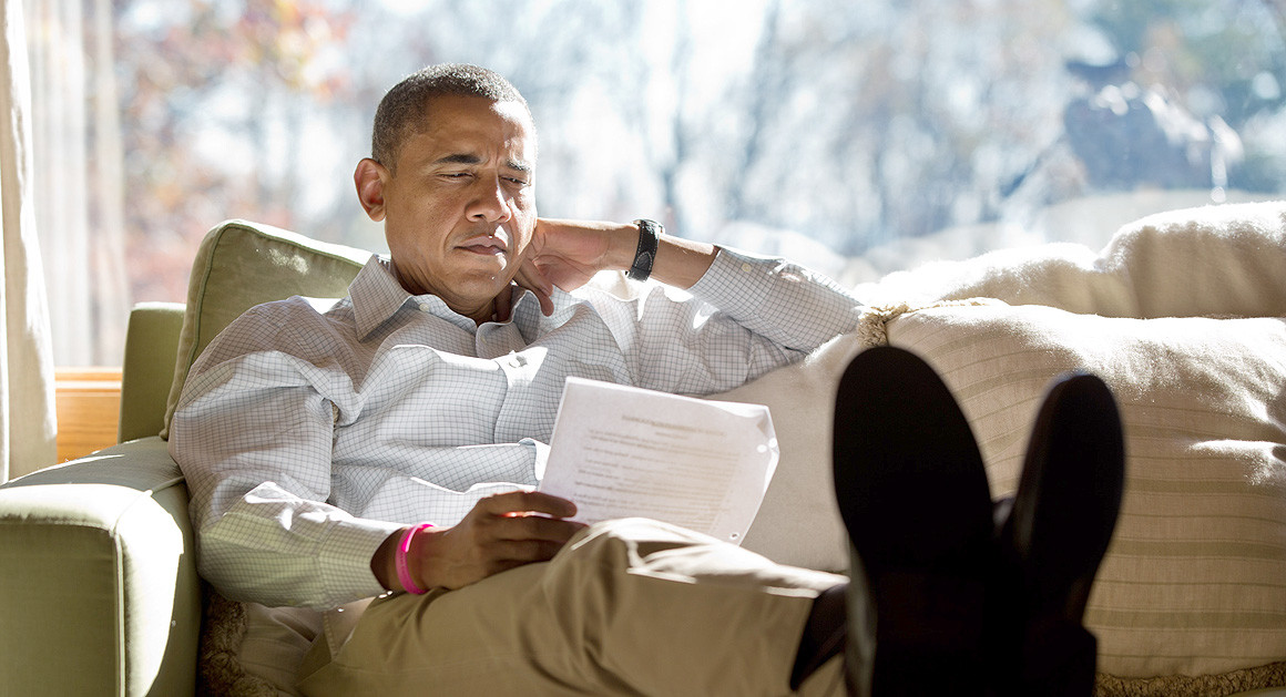 Obama reads on the couch